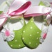 Mary Jane baby bootie shoes accented with a dainty flower and pink button, white and pink ribbon ties in sizes newborn to 18 months