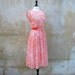 50s coral paisley pleated day dress/1950s summer sheer dress nipped waist full skirt
