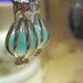 Opaque Teal Colored Glass bead in a beadcage earrings