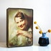 Vintage tin box depicting 1950s pin-up portrait