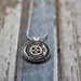 Small black and silver button pendant necklace