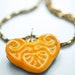 Orange and white Art Nouveau carving, carved out of tagua nut