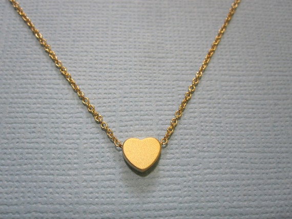 Items similar to Tiny gold heart Necklace on Etsy