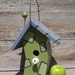 Crooked birdhouse, whimsical birdhouse, wood birdhouse, lime green and slate blue, painted-on patchwork, porcelain knob