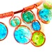 Wire wrapped necklace with blue, green and turquoise crackle glass beads, dark copper wire and adjustable chain
