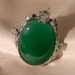 Ornate green glass vintage brooch with floral design