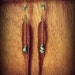 brown leather hand cut feathers with stacked turquoise chips hanging from gold chian
