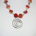 A Necklace of Fire Agate and Quartz Crystal Accented with Silver Beads and a Spiral Pendant with FREE Matching Earrings