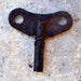 Vintage rusty wall clock key.