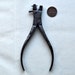 Old metal watchmaker tool.