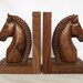 Two wooden horse bookends, hand carved