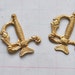 Two sword hilt stampings, raw brass