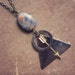 cosmo. a geometric arrow and astral bead necklace.