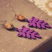 autumn. a pair of purple and amber boho leaf earrings.