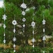 Tatting Christmas garland white snowflakes .