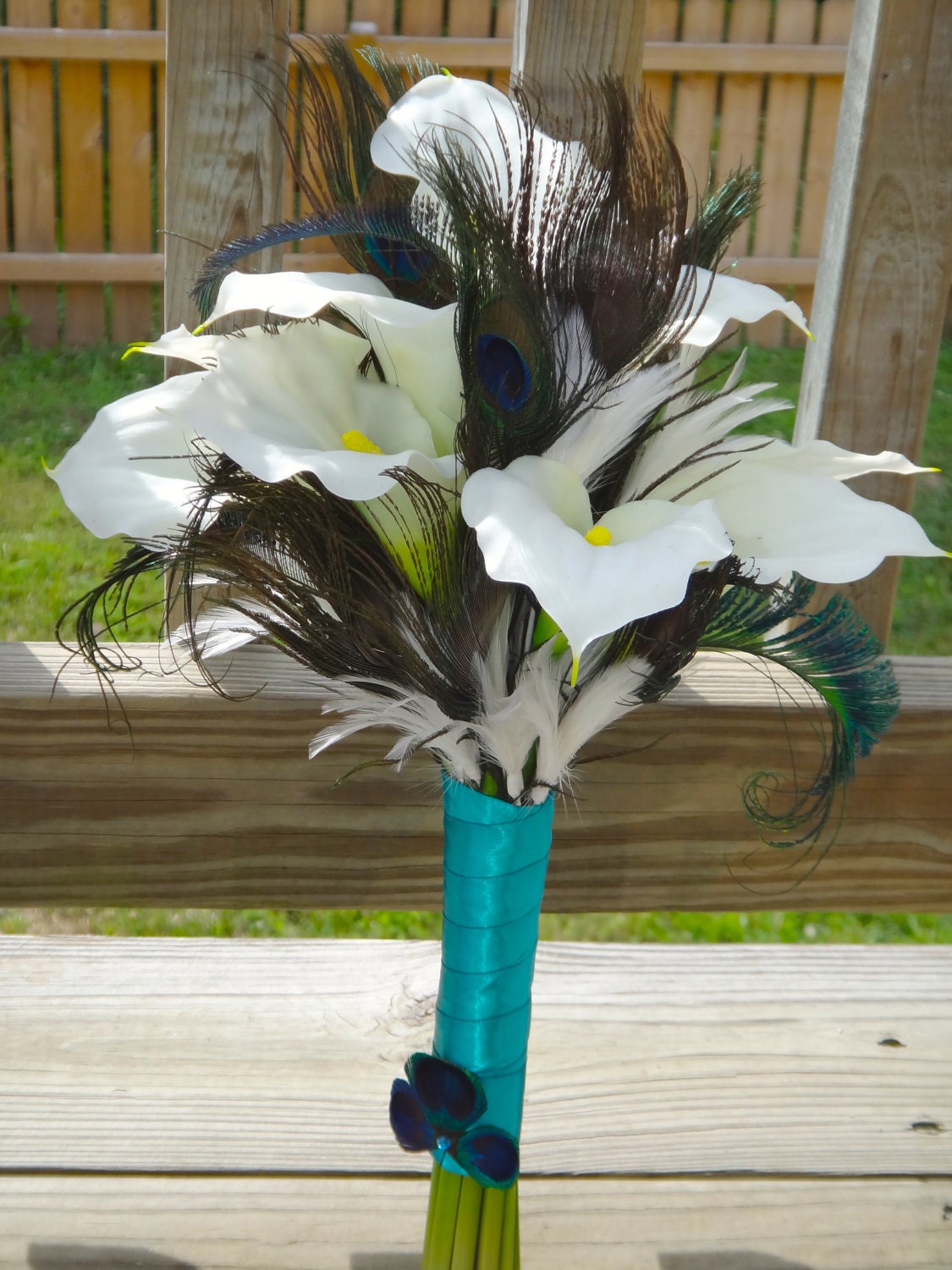 Calla lily bridal bouquet white and peacock feather accent