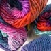 Noro Kureyon, color 277, fuchsia, teal, turquoise, red, black.