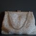 Hand beaded silver clutch with rhinestone clasp by Magid.