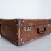 reserved for susie & andy - vintage battered brown board suitcase