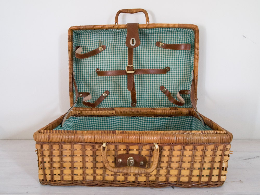 vintage wicker picnic basket with green checked interior