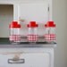 vintage french glass jars for storing foodstuff, made by Felix Potin in red and white checkered print