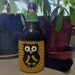 Black and Gold crocheted bottle / can / water bottle koozie with owl appliqué and neck strap. Who Dat.