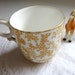 Charming Vintage Demitasse Cup with Caramel Colored Pattern and Gold Rim