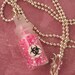 BIOHAZARD Bottle Of Neon Pink Biohazard Necklace