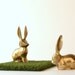 Curious brass bunny figurines