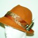 One-of-a-kind reddish-brown wool fedora adorned with beautiful vintage fabric and lovely pheasant feathers