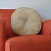 Round tan corduroy pillow