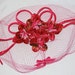 Vintage pink fascinator with flowers and birdcage veil