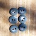Grey blue porcelain buttons with white spots.