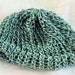 Baby girl's knitted green and blue beanie hat