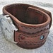 Quartz watch mounted on a leather cuff / wristband featuring turquoise, coral and silver bead inlay..