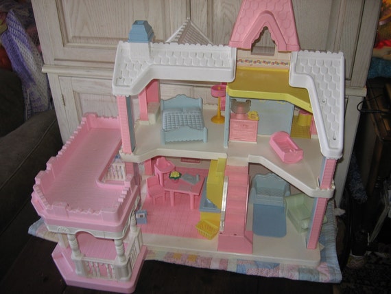 pink wooden dolls house