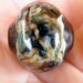 Hollow organic lampwork focal bead in ivory, blues, purples, browns, and black