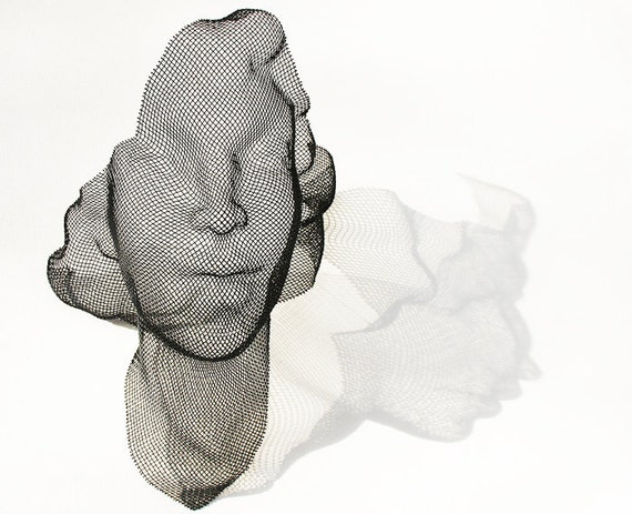 black wire mesh woman's face wall sculpture by HumanScaleStudio