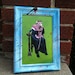 Framed surreal mixed media collage art. Cat man smoking a hookah.