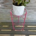 metal side table / hot pink faux bamboo plant stand. / 3 leg glass table
