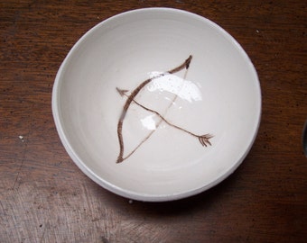 bow and arrow in a little bowl
