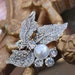 Beautiful silver color brooch with sparkling rhinestones and 1 pearl