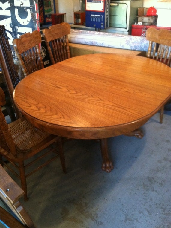 Items similar to Vintage Solid Oak Amish Claw Foot Pedestal Table with leaf and four hand carved