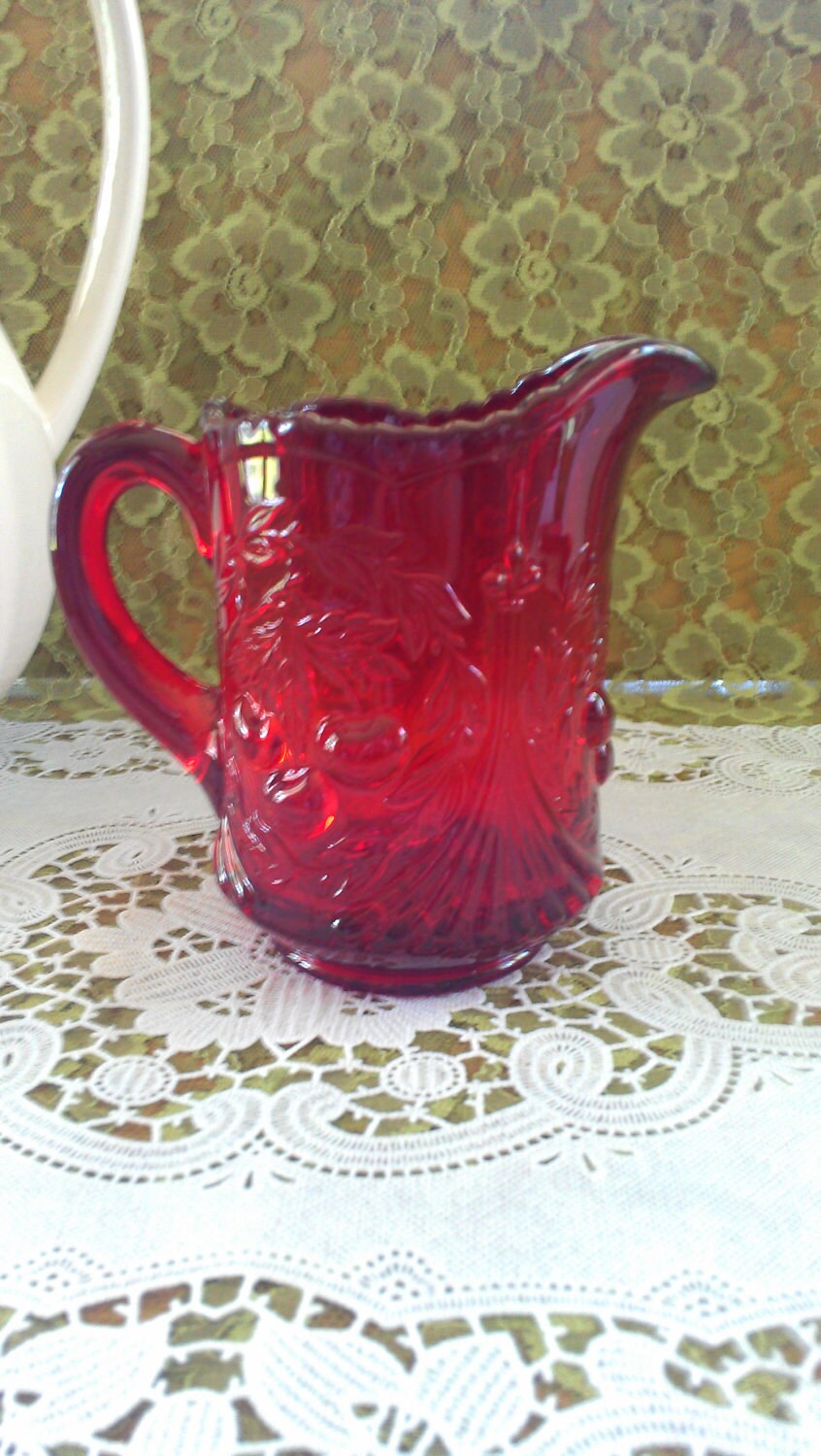 VTG red glass pitcher with raised cherry pattern