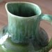 Small and green pottery syrup jar. Tuque Rouge. Quebec.