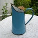 antique country blue enamel can or pitcher used as cider jug in Normandy