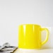 Two vintage mugs yellow white Fire King FireKing milkglass cups