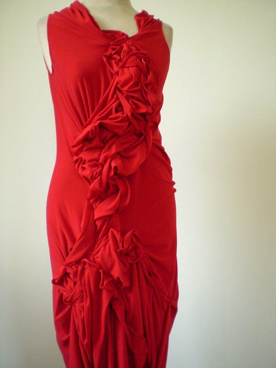 Red jersey dress with fabric manipulationhemline is