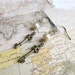 World Commuter tiny skeleton key and pearl earrings