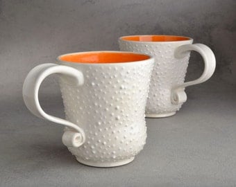 Dottie Mugs Made To Order Two White With Orange Interiors by Symmetrical Pottery